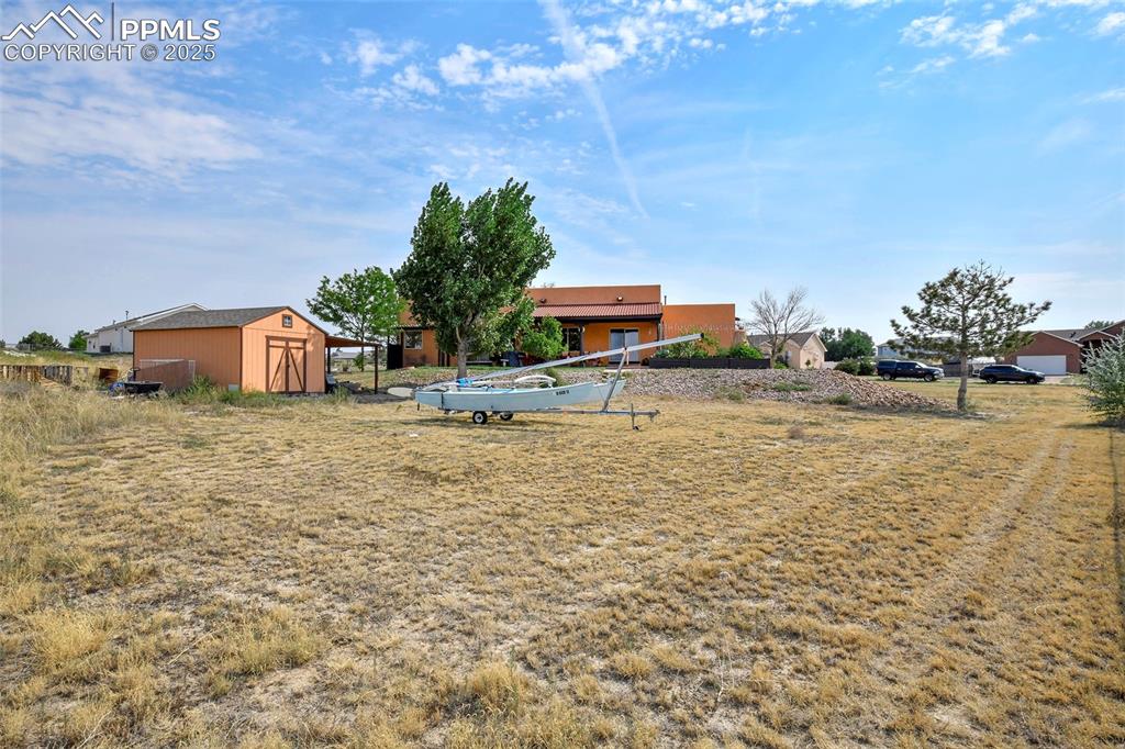 Image 20 of 22: View of yard with a shed