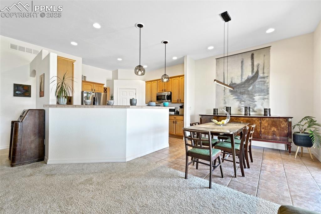 Image 6 of 22: Dining space featuring recessed lighting, light tile patterned flooring, an
