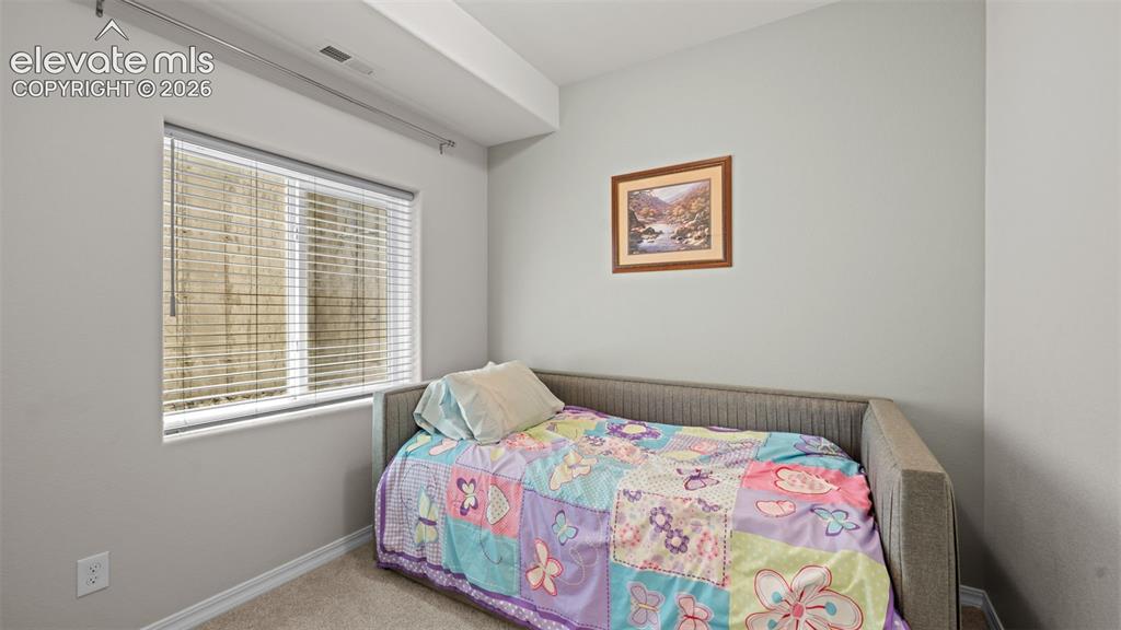 Image 15 of 45: Carpeted room featuring light gray walls, a window with horizontal blinds, 