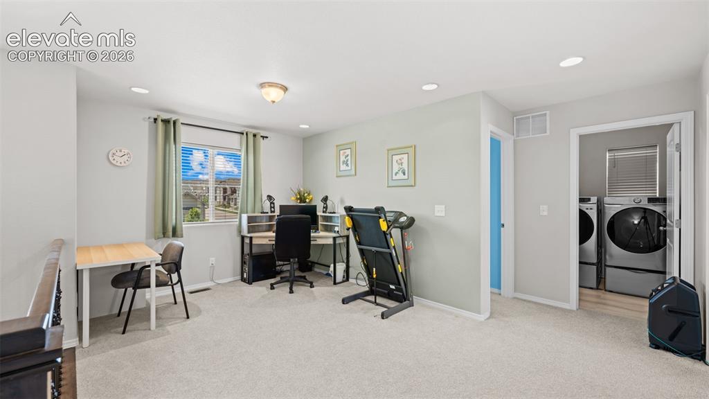 Image 23 of 45: Versatile loft area featuring a window with blinds, recessed lighting, a fl