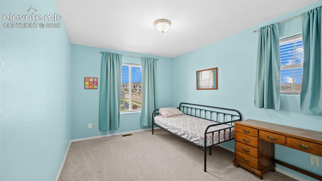 Image 25 of 45: Carpeted interior room with light blue textured walls