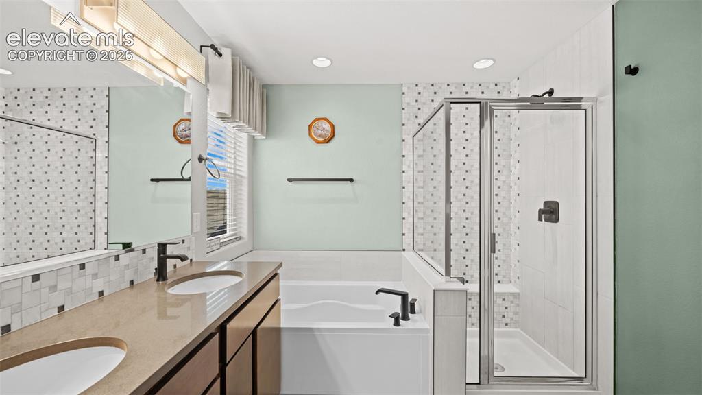 Image 29 of 45: Spacious bathroom featuring a double vanity with integrated sinks, a built-