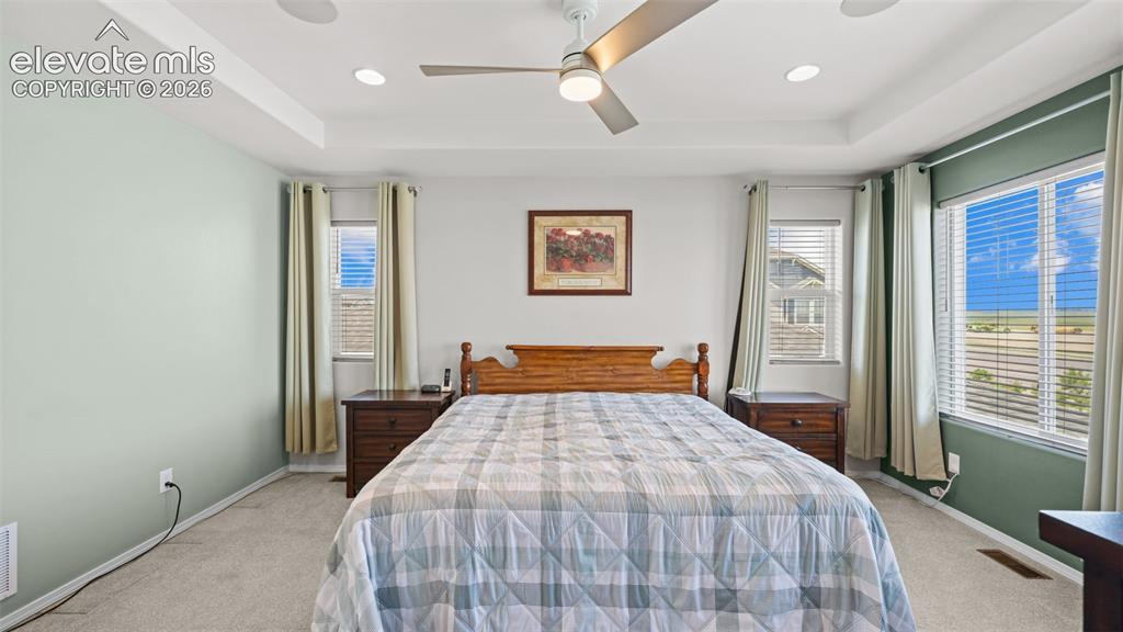 Image 30 of 45: Spacious room featuring a tray ceiling with recessed lighting and a ceiling