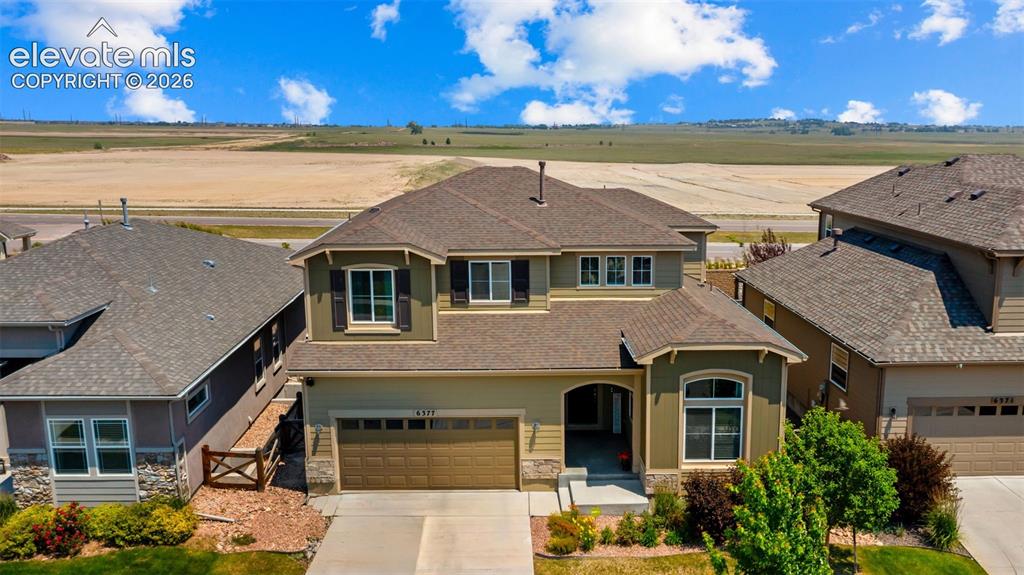 Image 35 of 45: Two-story residence featuring a two-car garage, front porch entry, and a co