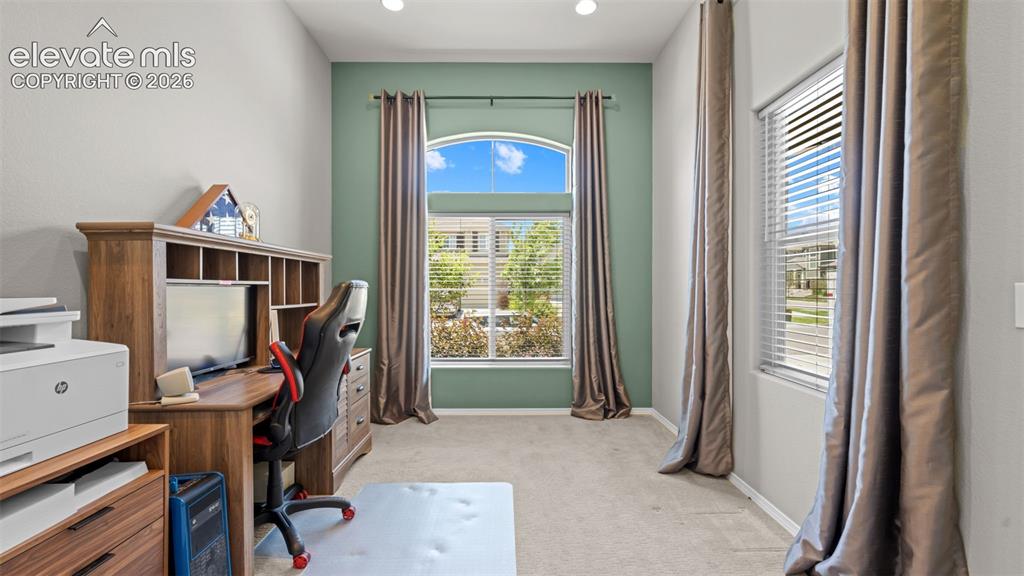 Image 5 of 45: Bright room featuring high ceilings, a large arched window, and a secondary