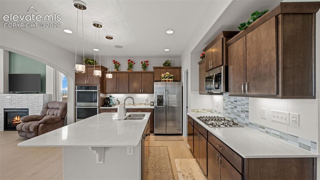 Image 7 of 45: Contemporary kitchen featuring a spacious island with a double basin sink, 