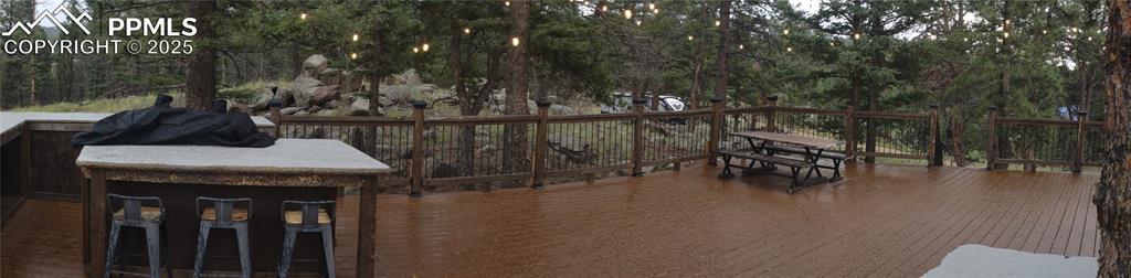 Image 45 of 50: Deck with lights at dusk