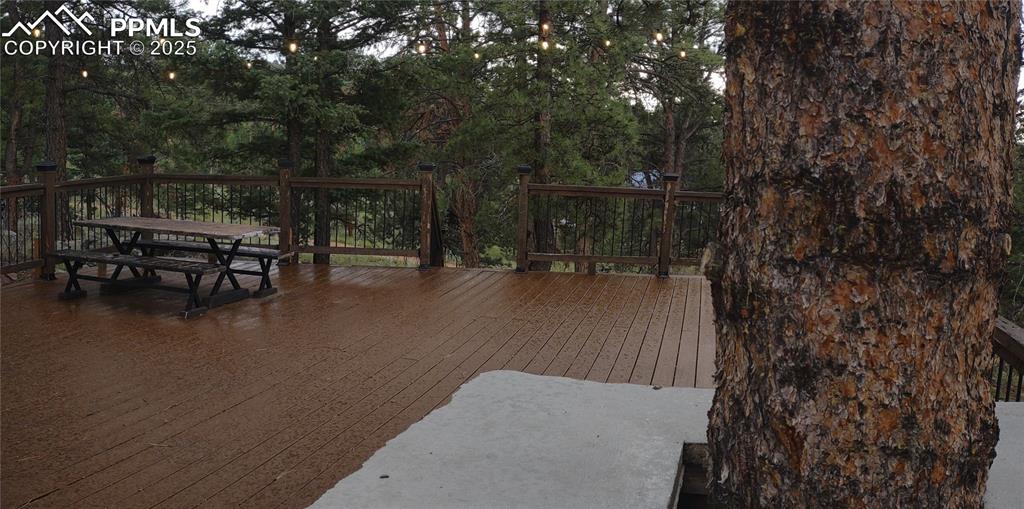 Image 47 of 50: Deck with lights at dusk
