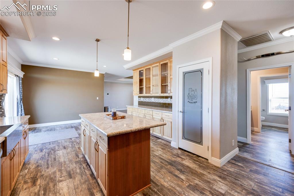 Image 11 of 50: Kitchen featuring healthy amount of natural light, ornamental molding, deco