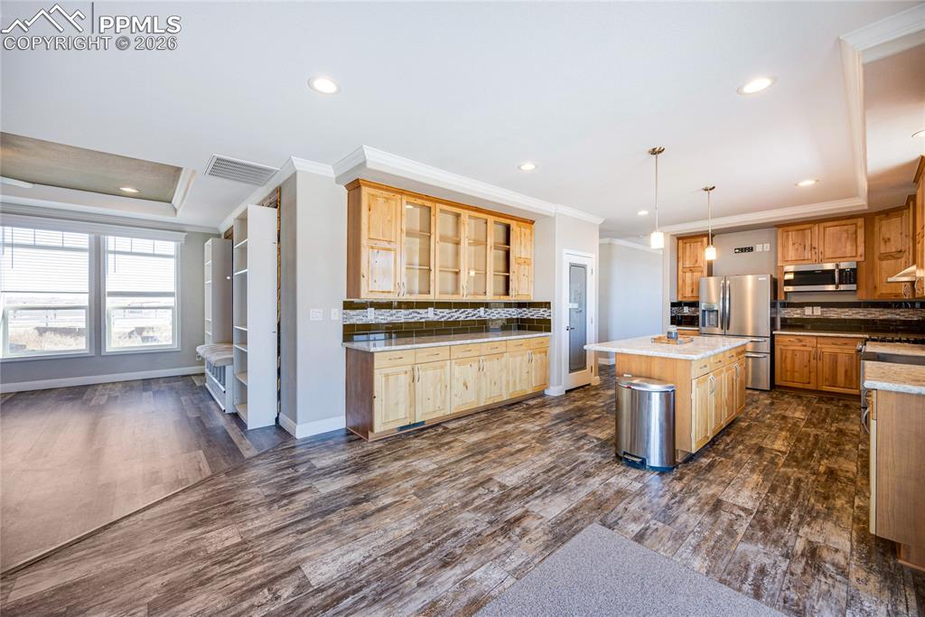 Image 6 of 50: Kitchen with decorative backsplash, hanging light fixtures, recessed lighti