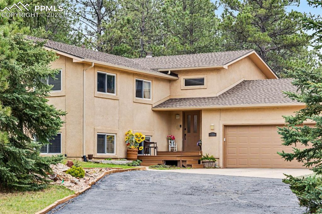 Image 1 of 44: Set against a brilliant blue sky, the two-story stucco home is nestled with