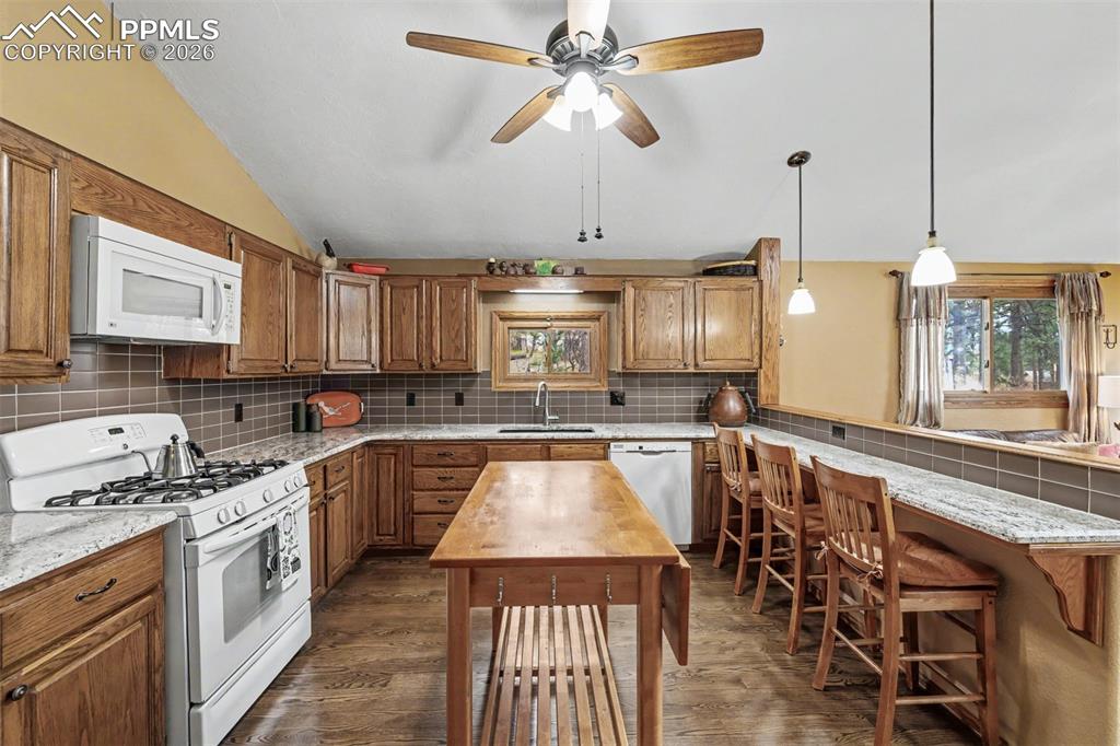 Image 10 of 44: Wraparound pine forest views make this family room the perfect spot for mov