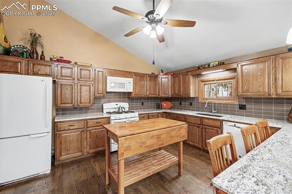 Image 11 of 44: The dramatic stacked-stone fireplace commands the room while built-in shelv