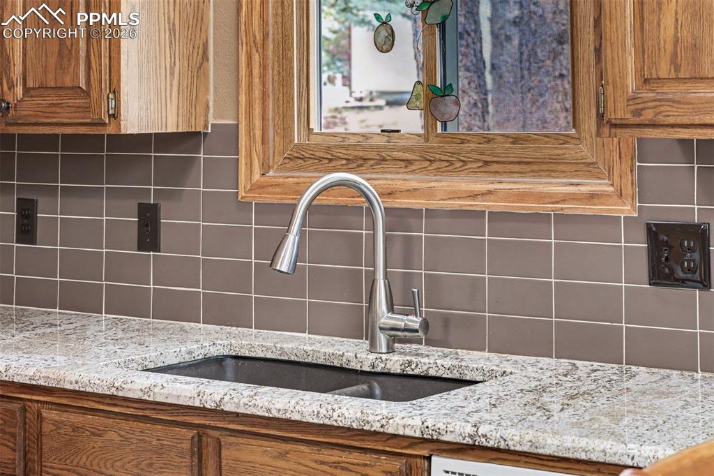 Image 12 of 44: Wood beams cross the vaulted ceiling as the family room opens naturally int