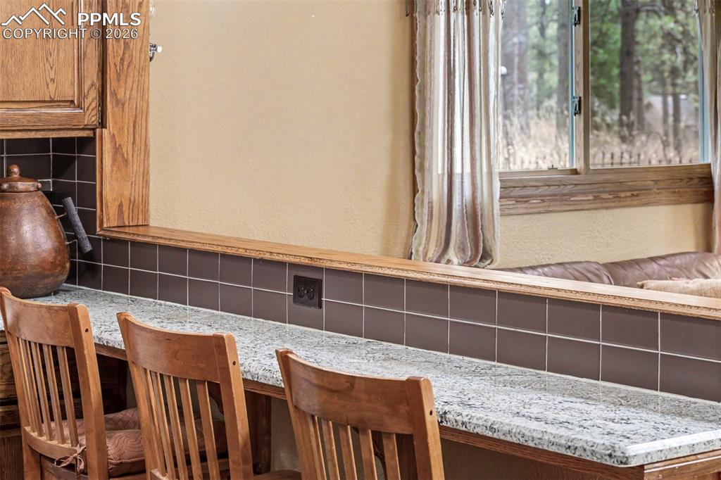 Image 13 of 44: A skylight floods the kitchen with natural light, while granite countertops