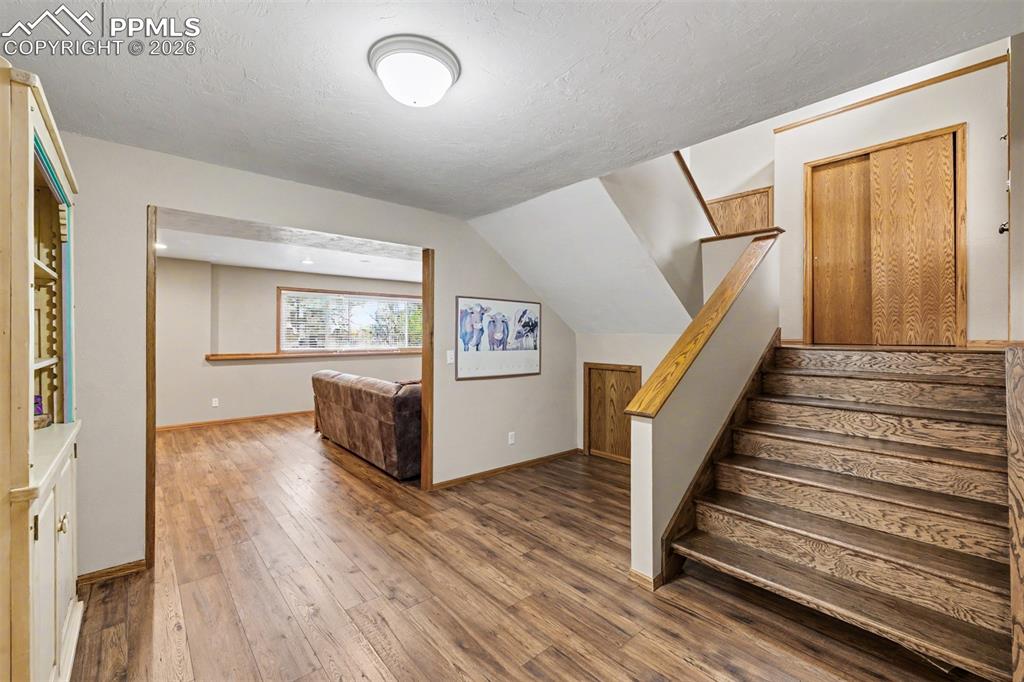 Image 24 of 44: The renovated primary bath features a frameless glass walk-in shower with s