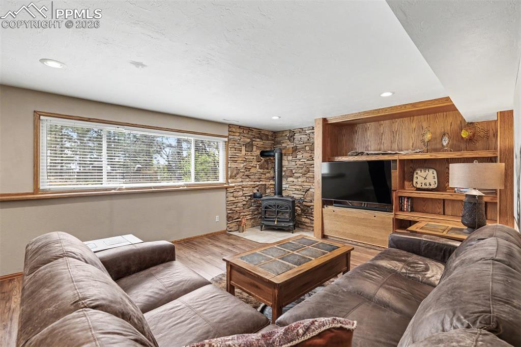 Image 26 of 44: The bedroom window frames an expansive panorama of rolling hills and distan