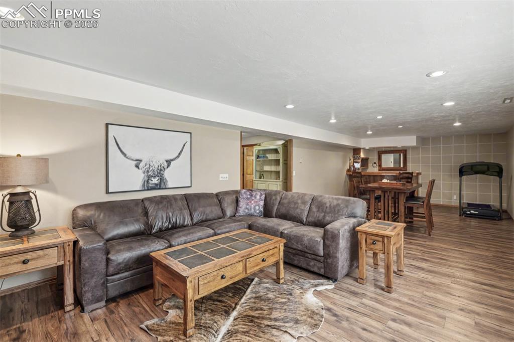 Image 27 of 44: Clean and functional, this full bathroom features warm wood vanity cabinetr
