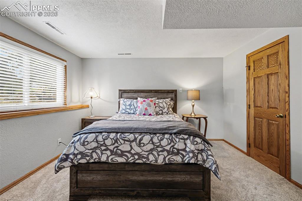 Image 30 of 44: A built-in entertainment center and a wood-burning stove nestled against a 