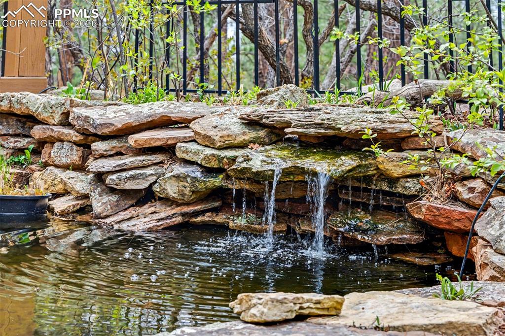 Image 40 of 44: Seen from the far reaches of the property, the home sits comfortably within