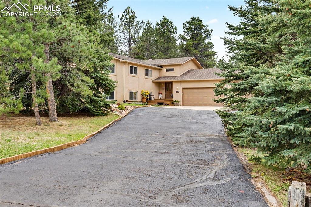 Image 41 of 44: Water cascades in graceful curtains over a hand-laid stone ledge into the p