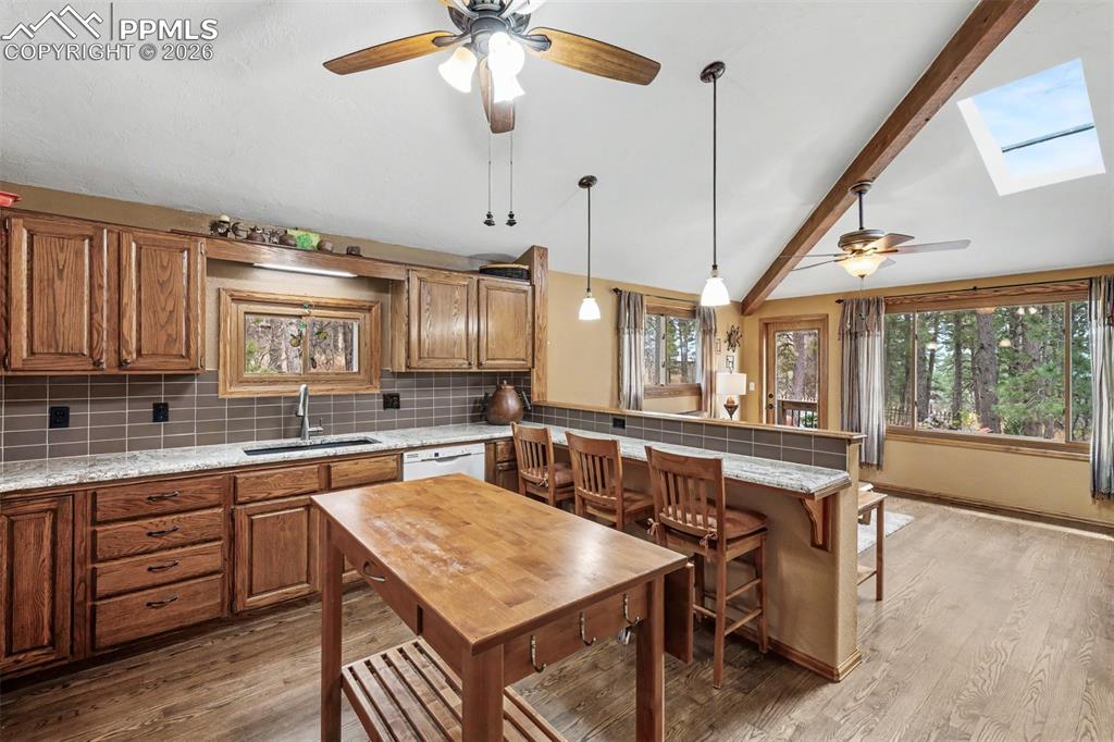 Image 9 of 44: The floor-to-ceiling travertine stone fireplace is the undeniable heart of 