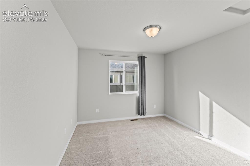 Image 10 of 17: Carpeted flooring, single window, flush-mount ceiling light fixture, neutra