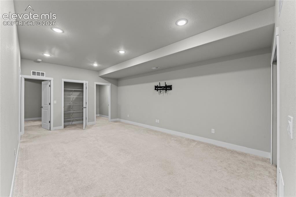 Image 14 of 17: Spacious recreation room featuring recessed ceiling lighting, neutral carpe