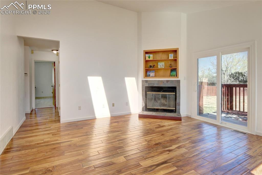 Image 11 of 36: Family room wood burning fireplace