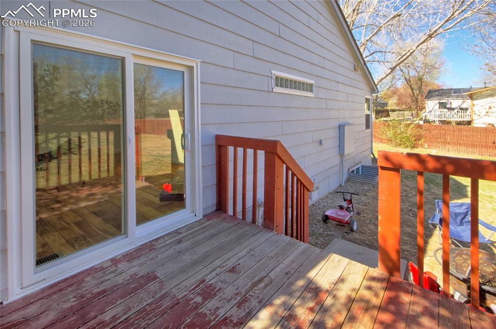 Image 30 of 36: Family room walks out to wood deck