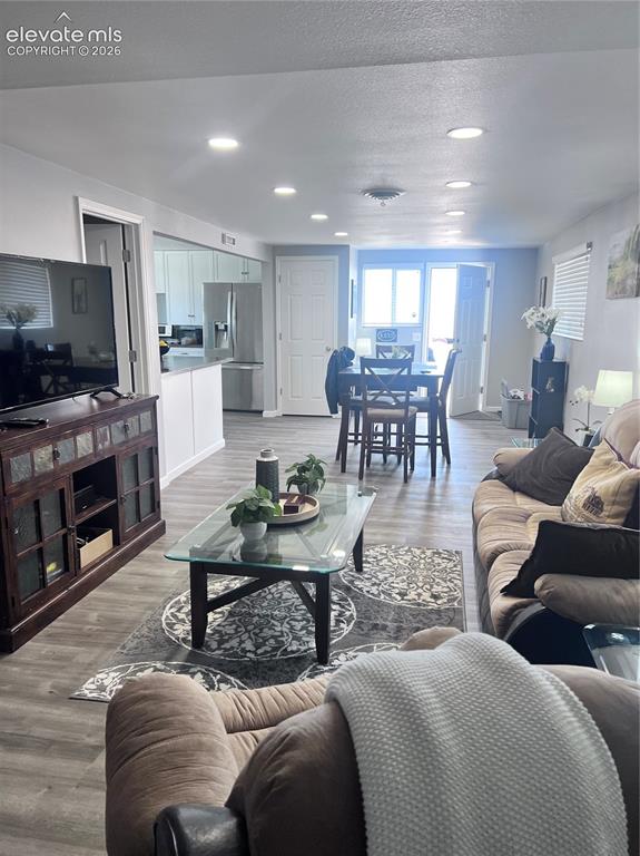 Image 29 of 49: Recessed lighting, wood-finish flooring, white paneled doors, stainless ste