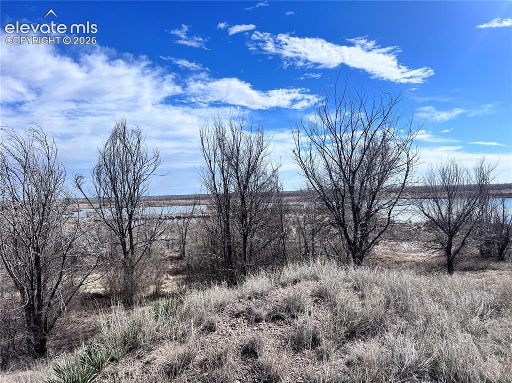 Image 34 of 49: Expansive natural landscape with a prominent body of water, open terrain, a