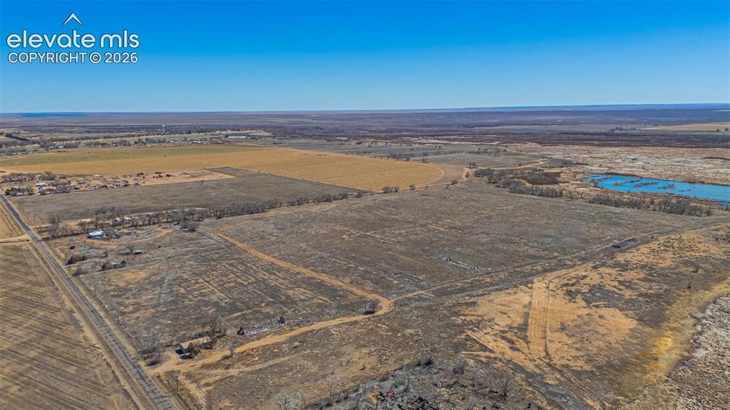 Image 39 of 49: Expansive land offering diverse terrain, including cultivated fields, open 