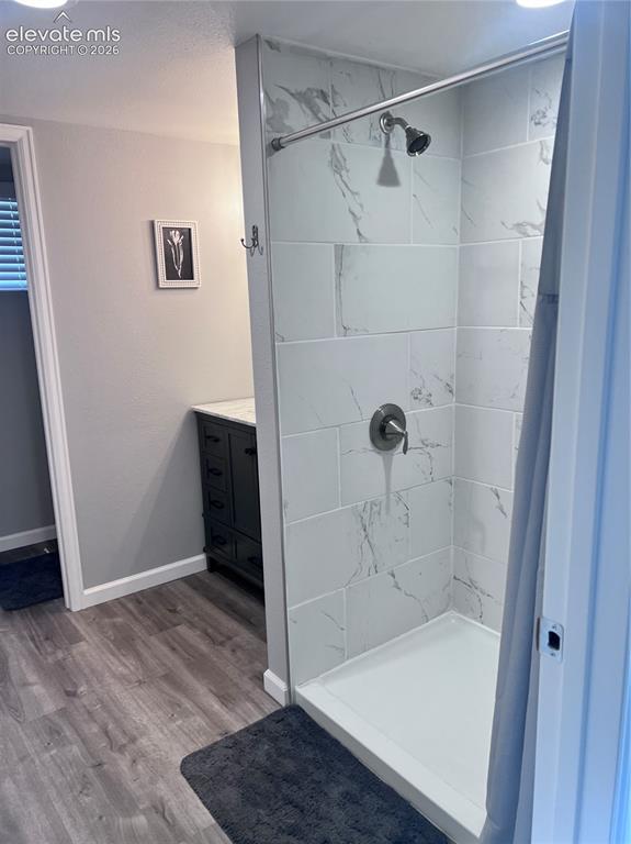 Image 4 of 49: Shower with white tiled walls, brushed nickel fixtures, and a white shower 