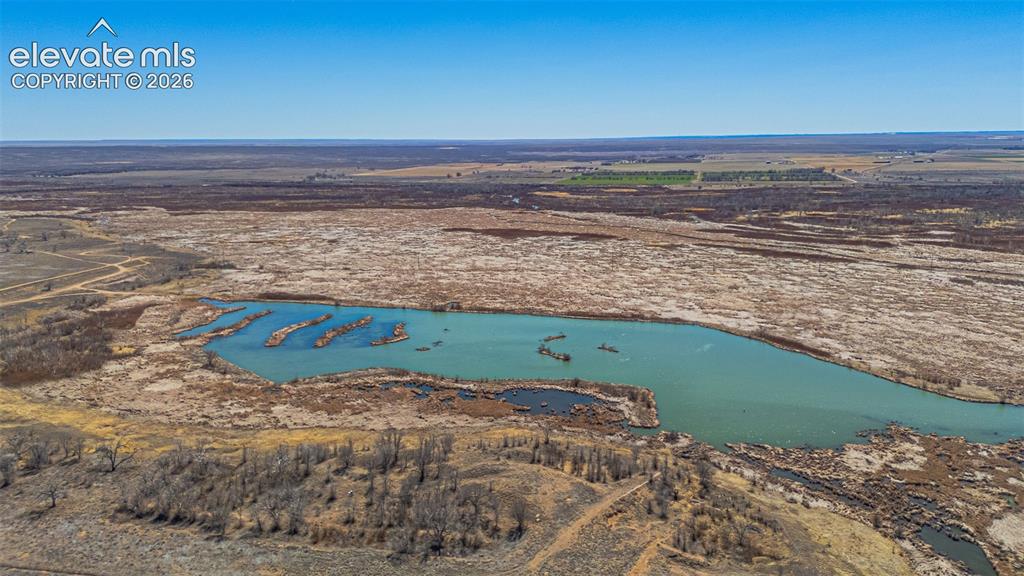 Image 48 of 49: Expansive body of water with multiple small land formations, surrounded by 