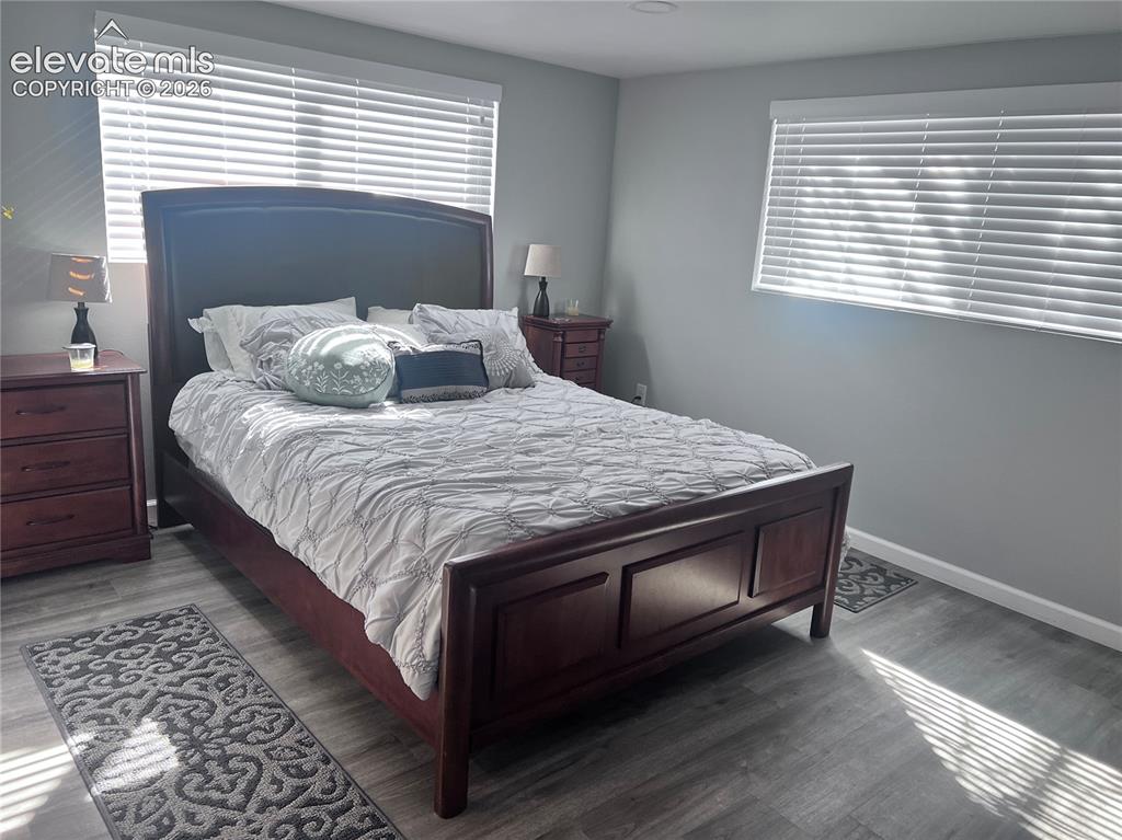 Image 6 of 49: Wood-finish flooring, multiple windows with blinds, and recessed lighting