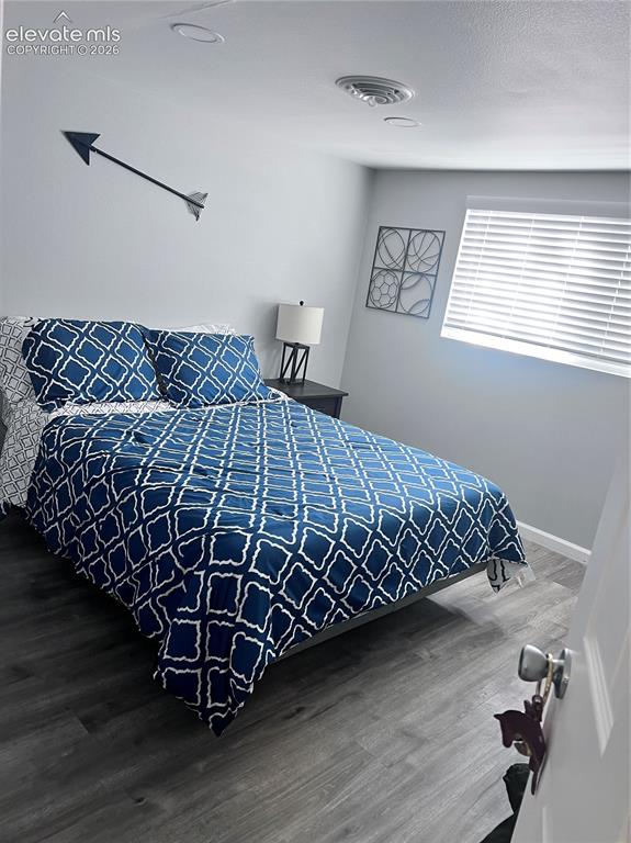 Image 7 of 49: Wood-finish flooring, recessed lighting, ceiling-mounted register, window w