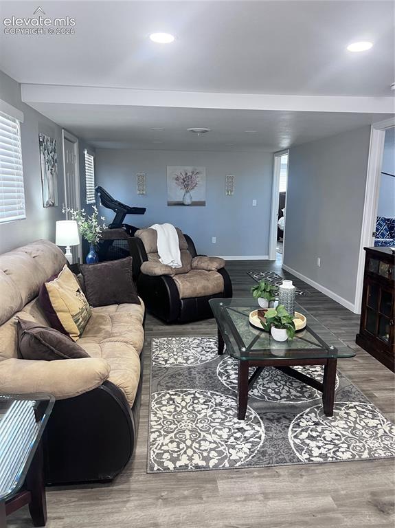 Image 9 of 49: Recessed ceiling lighting, wood-finish flooring, interior windows with blin