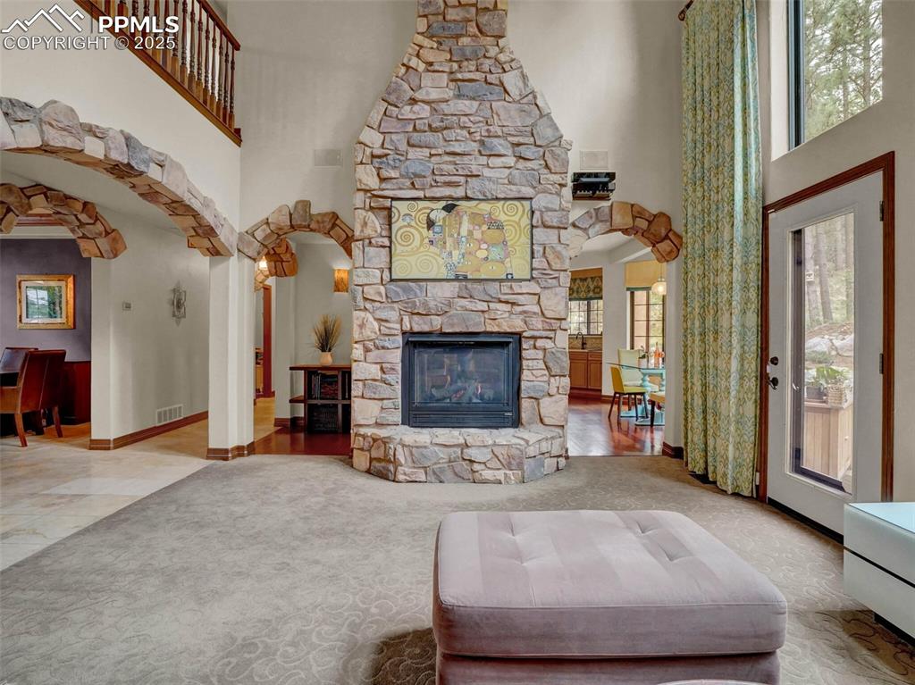 Image 14 of 37: Dual sided fireplace adjoins kitchen