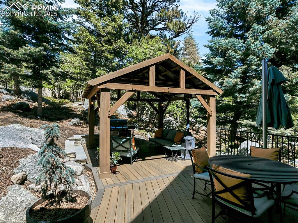 Image 23 of 37: Backyard patio with Gazebo, BBQ