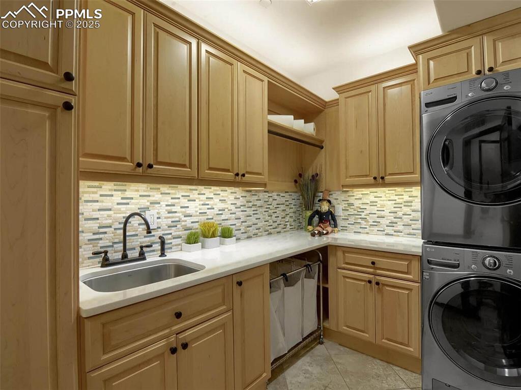 Image 24 of 37: Large main level laundry with lots of cabinetry