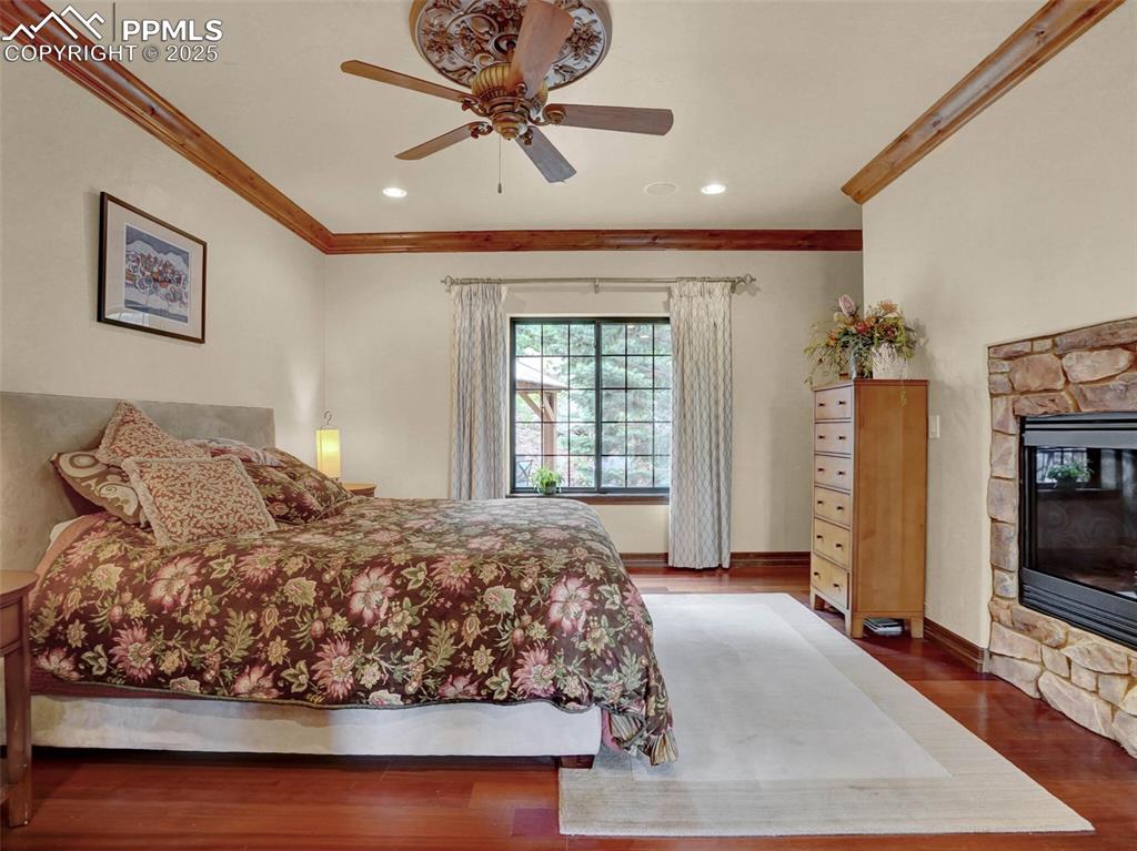 Image 26 of 37: Primary bedroom with fireplace and Brazilian wood flooring