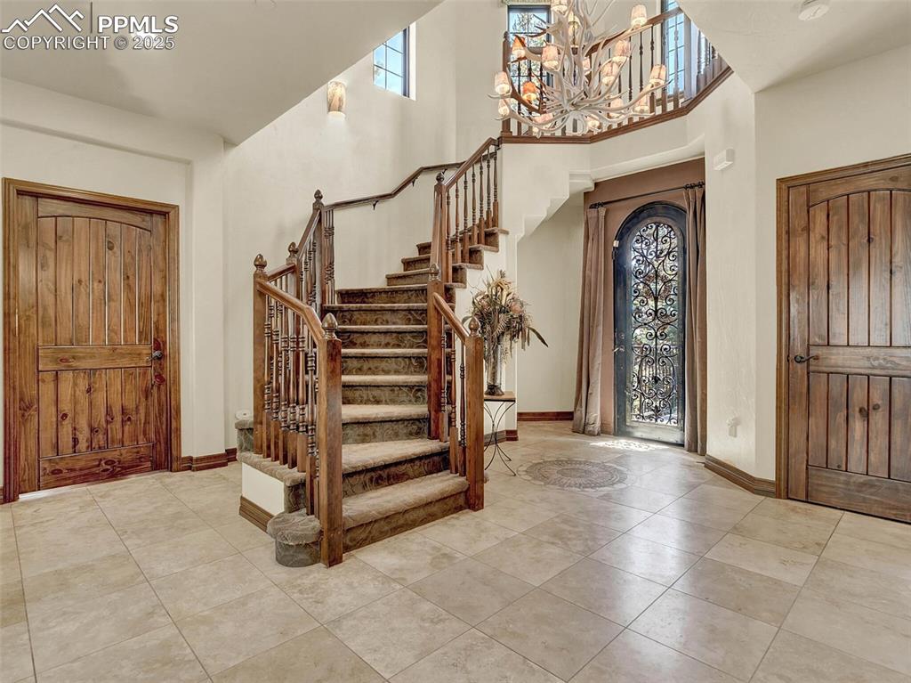 Image 7 of 37: Entry foyer with travertine tile and in-lay