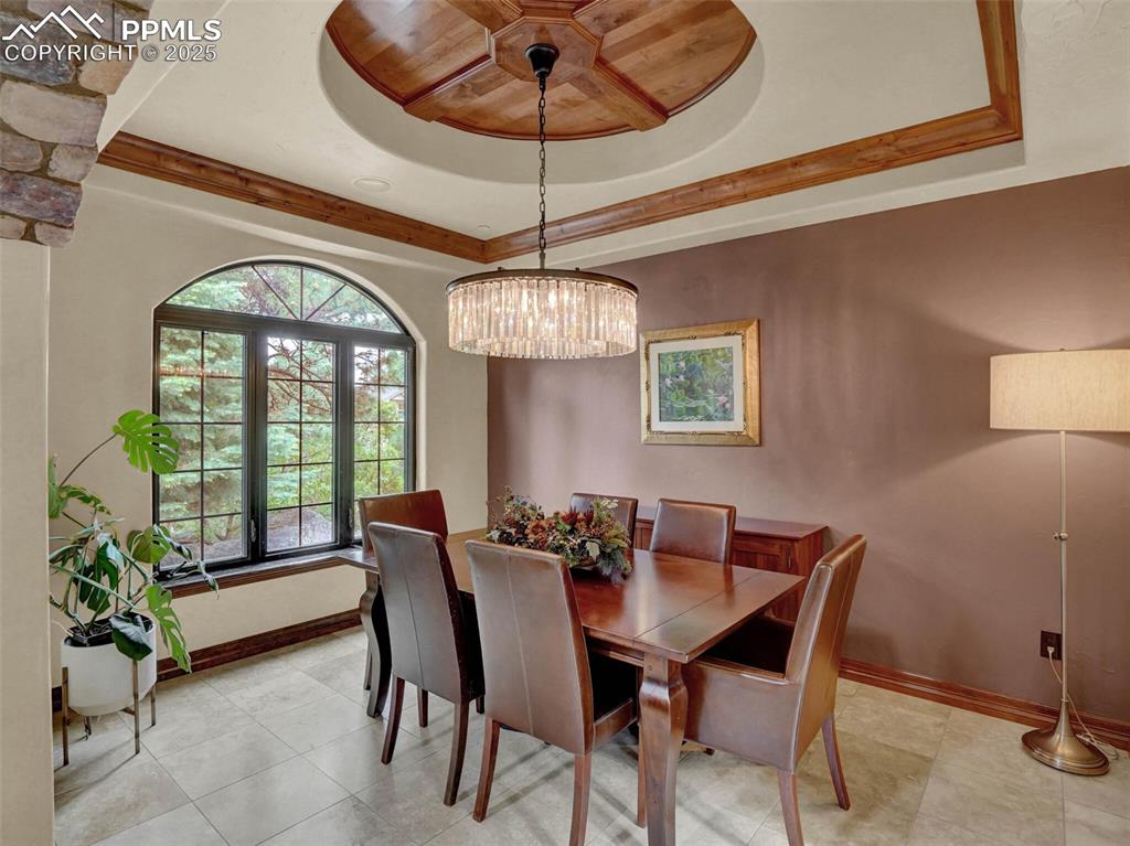 Image 8 of 37: From foyer looking into formal dining room. Coffered ceiling with wood in-l