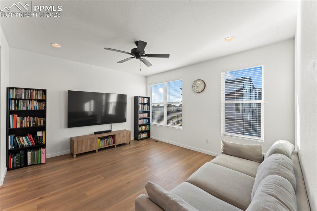 Image 14 of 31: Living room featuring wood finished floors, recessed lighting, and a ceilin