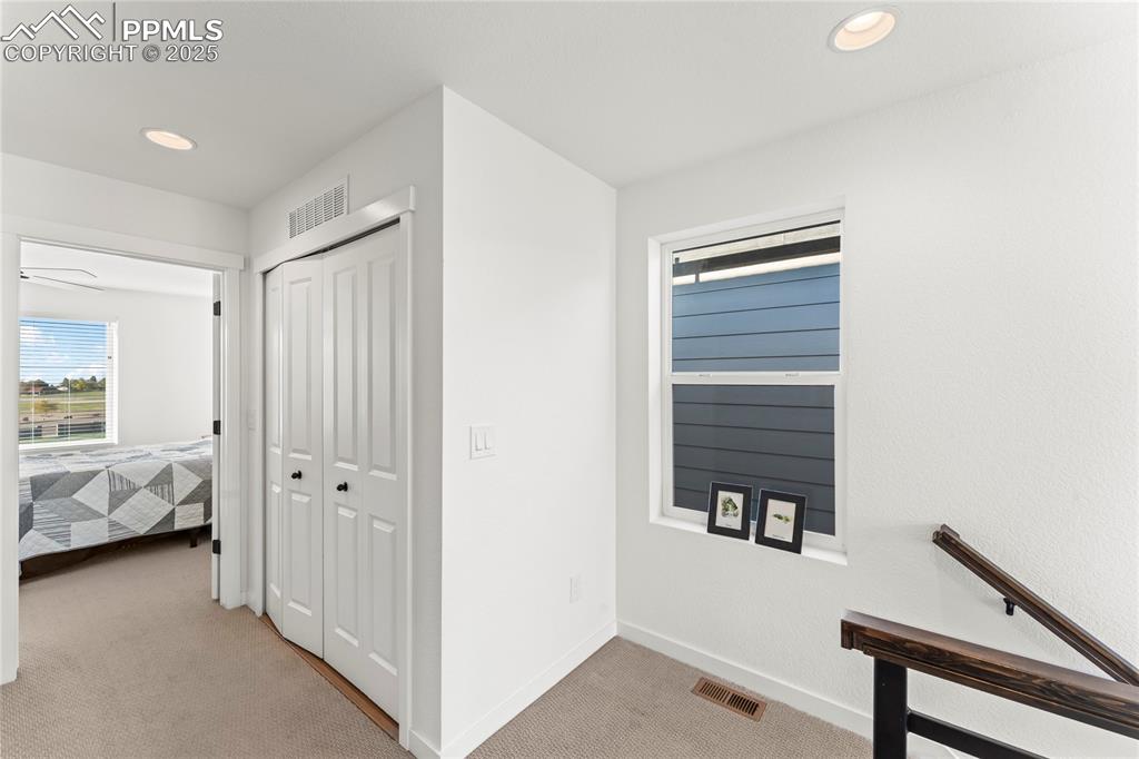 Image 18 of 31: Hallway featuring light carpet and recessed lighting