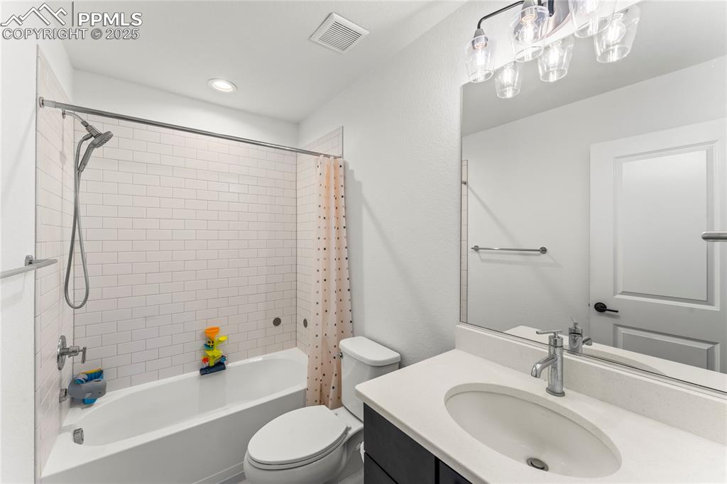 Image 29 of 31: Full bath with shower / bathtub combination with curtain, vanity, and reces