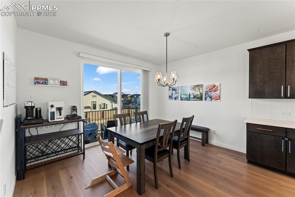 Image 9 of 31: Dining area with dark wood-type flooring and a chandelier