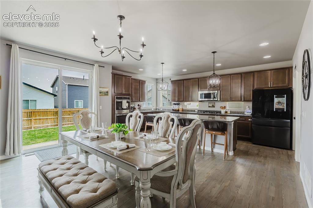 Image 13 of 46: Open-concept living space featuring wood-finish flooring