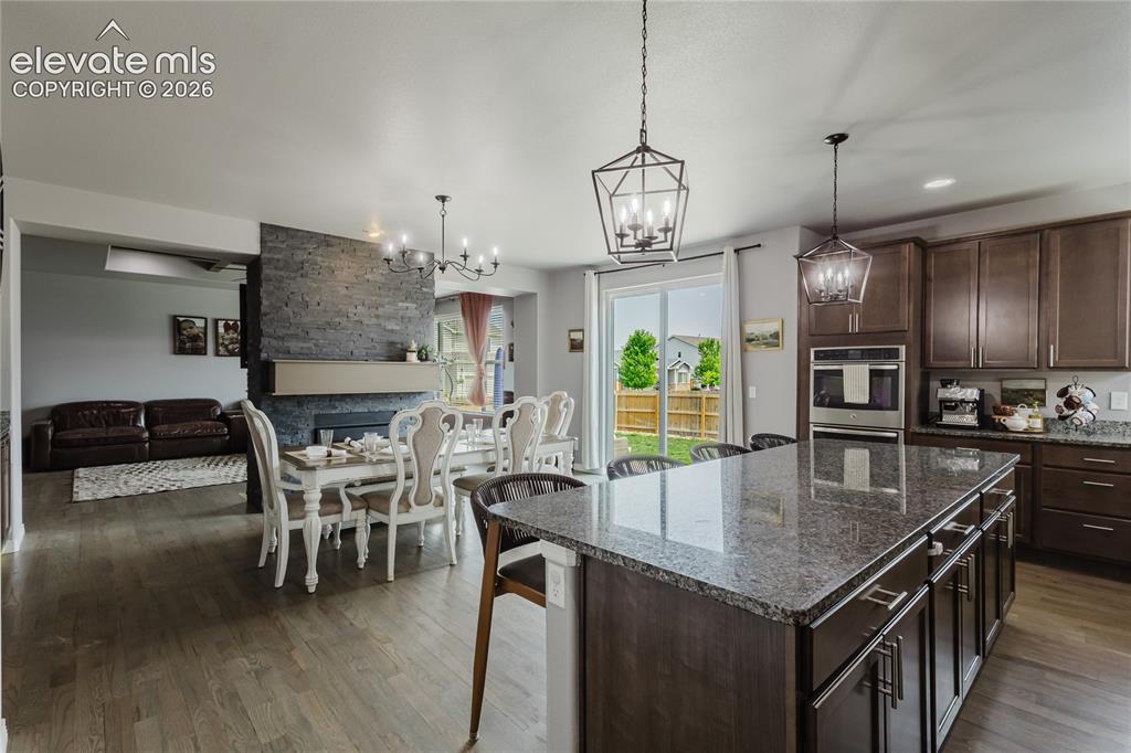 Image 18 of 46: Kitchen featuring wood-finish flooring and a central island with a granite-